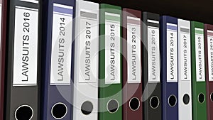 Line of multicolor office binders with Lawsuits tags different years
