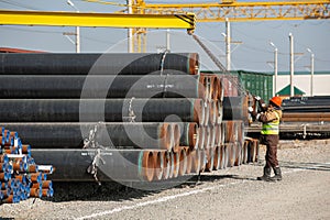 Line of oilfield large streel pipes in industrial construction area