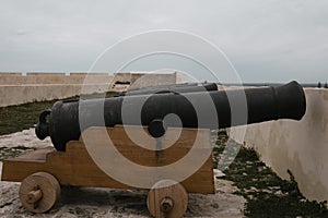 Old cannons in line over a wood platform