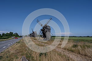 A line of old windmills on a plain