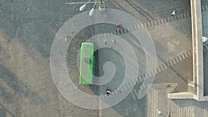 Line of Passengers getting on the bus, top view drone shot.