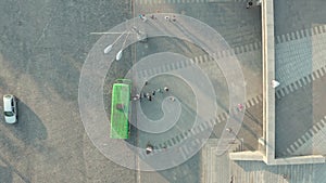 Line of people getting on the bus, top view drone shot.