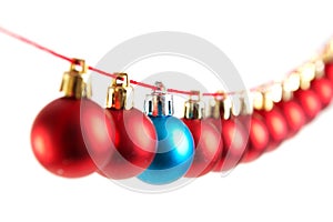 Line of red and blue christmas balls on white background. Christmas decorations.