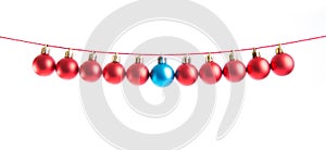 Line of red and blue christmas balls on white background. Christmas decorations.