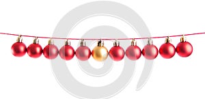 Line of red christmas balls and one gold or yellow ball on white background. Christmas decorations.