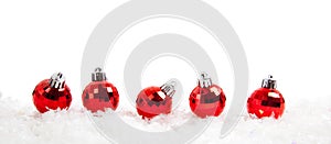 Line of Red christmas balls on snow