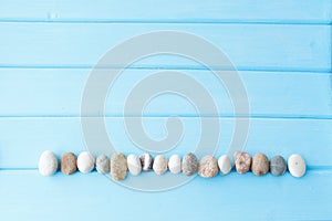 Line of sea stones on a wooden table