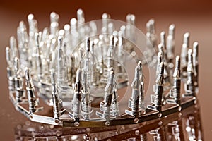 Line of Silver Tinned External PCB Angular Connectors Over Reflective Surface