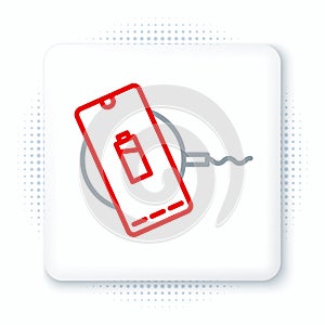 Line Smartphone charging on wireless charger icon isolated on white background. Charging battery on charging pad