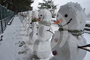 line of snowmen being used as a barricade