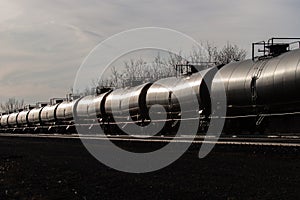 Line of Tank Cars Glinting in Sun