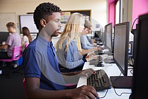 Line Of Teenage High School Students Studying In Computer Class