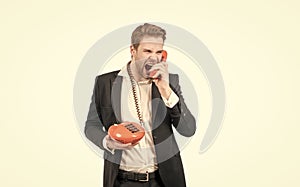 Line telephony. Angry man shout in telephone receiver. Businessman is on landline telephone. Retro connection.