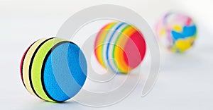 Line of Three Brightly Coloured Patterned Foan Balls.