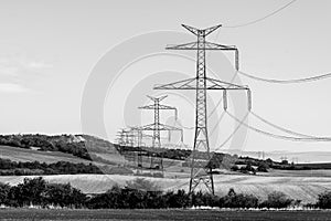 Line of transmission towers, or electricity pylons, in the rural landscape