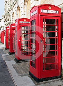 Line of typical old fashioned british red public telephone boxes outside the former post office in Blackpool Lancashire