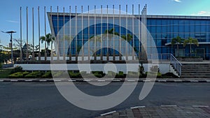 Line up of Flagpoles in Front of Building