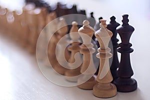 Line of wooden chess pieces photo