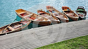 Line of Wooden Rowboats Tied to Dock