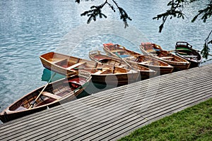 Line of Wooden Rowboats Tied to Dock