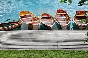 Line of Wooden Rowboats Tied to Dock