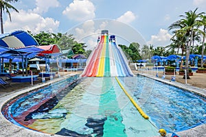 Lineal colorful striped water slider in the water park
