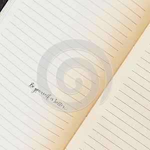 Lined notebook with a handwritten motivational phrase.