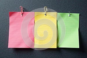 Lined notepad sheets magnetically affixed to dark gray board , surface, dark, information