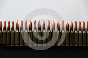 Lined Up Ammunition With Cartridges On Black And Bullets On White Backgrounds