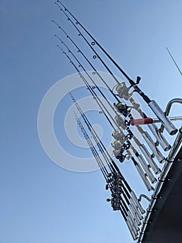 Lined up fishing rods on the top of the boat roof