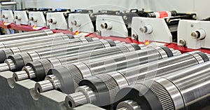 Lined up magnetic cylinders for die cut on rotary printing press. Magnetic cylinder for flexo rotary die cutting.