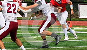 Lineman blocking for the running back during a football game