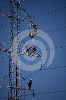 linemen working on a high power transmission line photo