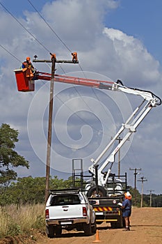 Linemen working on powerline photo