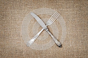 Linen background with fork and knife crossed