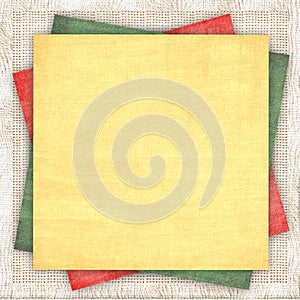 Linen background with a multi-coloured paper