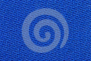 The linen cloth in blue color. Fabric background texture. Detail of textile material close-up