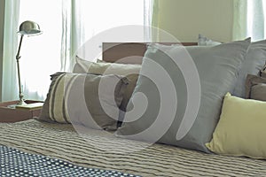 Linen pillows in difference size on bed in modern japanese style bedroom