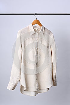 Linen shirt hanging on wooden hanger