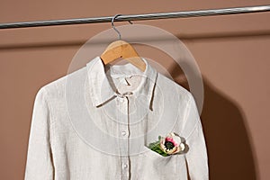 Linen shirt hanging on wooden hanger close up