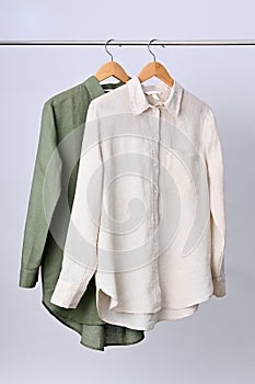 Linen shirts hanging on wooden hangers