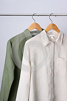 Linen shirts hanging on wooden hangers