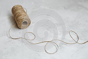 Linen thread spool on a textured gray background