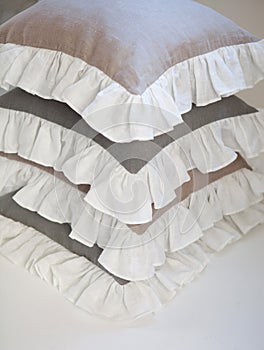 Romantic ruffled linen pillows stack isolated