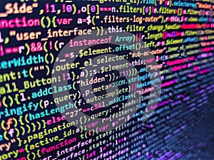 Lines of code of a software with several colors. Software developer programming code on black screen. Abstract modern virtual