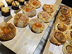 Lines of fresh baked sweet puff pastry stuffed with apricot and peach jelly