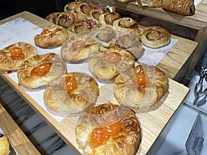 Lines of fresh baked sweet puff pastry stuffed with apricot and peach jelly