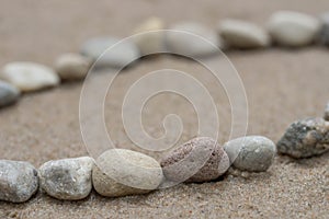 Lines of pebbles on sand macro