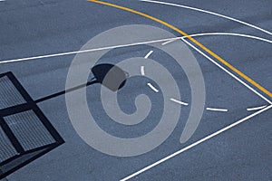 Lines and shadows on a basketball playground under the sunlight