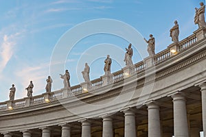 Lineup of roman statues at St Peter`s square in Rome Italy on ga